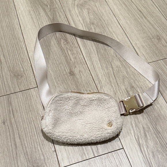 lululemon athletica Handbags - Lululemon Ivory Sherpa Belt Bag with Gold Accents